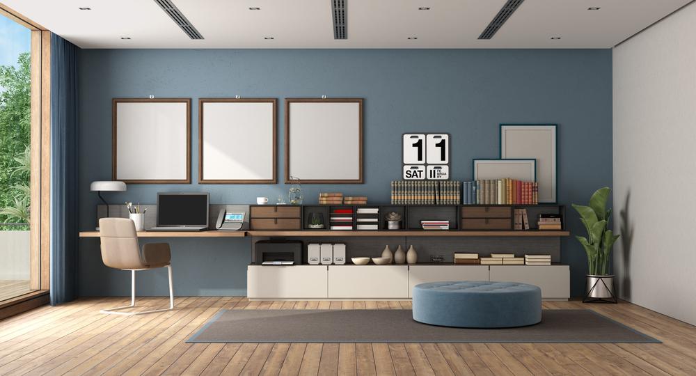 Work at home in a large room with desk and sideboard against blue wall - 3d rendering
Note: the room does not exist in reality, Property model is not necessary