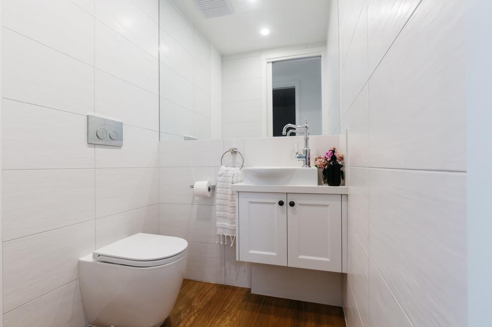 Bright white contemporary powder room in an Australian home